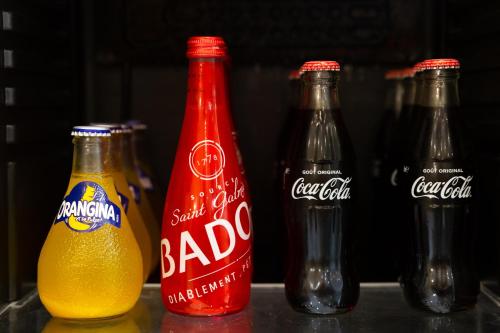 four bottles of coca cola and a bottle of soda at Serenity Villa - Détente & Chill in Cormeilles-en-Parisis