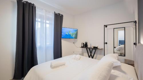 a bedroom with a white bed and a mirror at Modern Room in Olbia