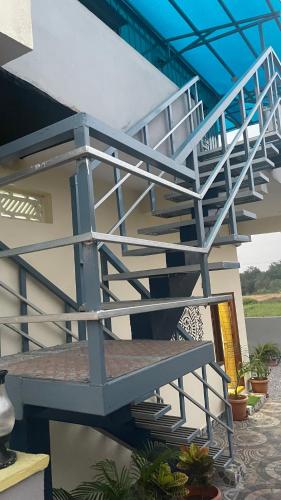 a metal staircase on the side of a house at Vididillu in Pāloncha