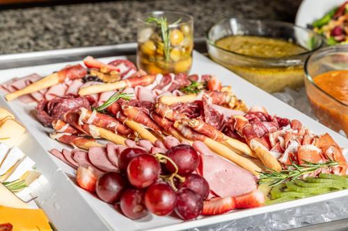 a plate of food with meat and vegetables on a table at Sheraton Guayaquil in Guayaquil