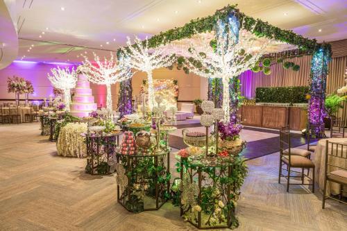 a wedding reception with a wedding cake and trees at Sheraton Guayaquil in Guayaquil
