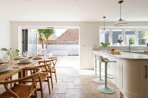 a kitchen and dining room with a table and chairs at Chic 4-Bed Coastal Retreat in Heart of Bosham in Bosham