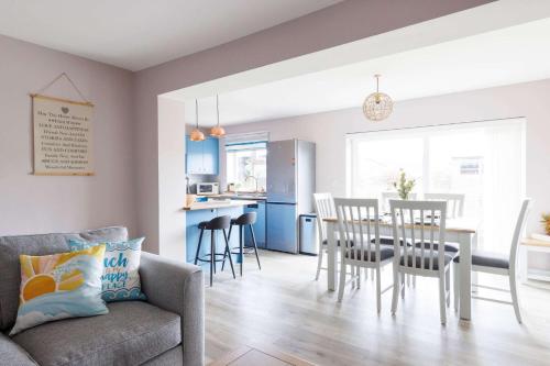 a living room with a couch and a table and chairs at Home from home 3-Bed Nr East Wittering Beach in East Wittering