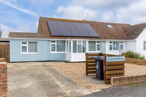 a house with a solar panel on the roof at Home from home 3-Bed Nr East Wittering Beach in East Wittering
