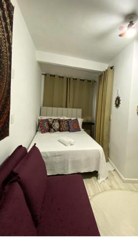 a bedroom with a large white bed in a room at Apêzinho Vidigal - RJ in Rio de Janeiro