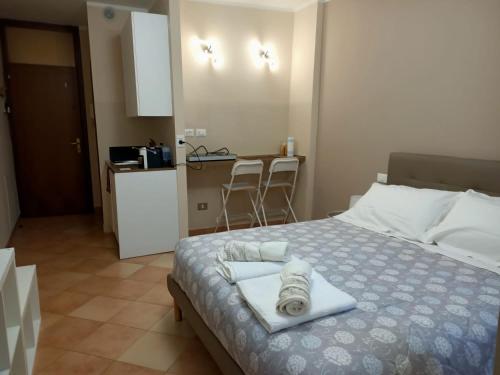 a bedroom with a bed with two towels on it at La Rosa Cesena in Cesena
