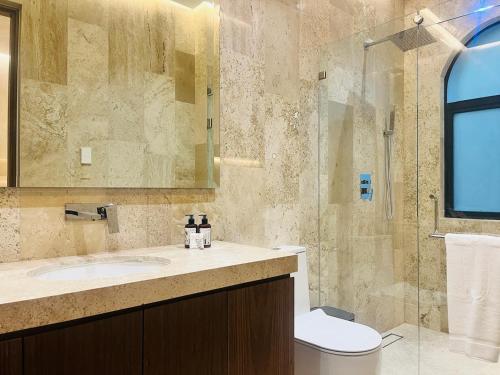 a bathroom with a sink and a glass shower at Hotel Casa Ensenada Luxury Boutique Hotel in Mexico City