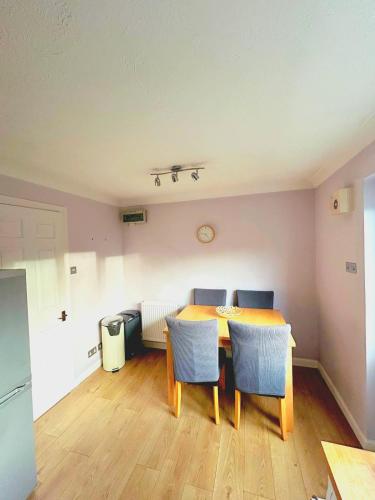 a dining room with a table and chairs at 2 Bedroom House off A12 Colchester in Lexden