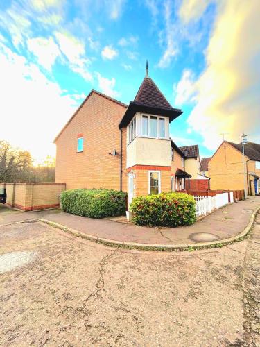 a large brick house with a turret on a street at 2 Bedroom House off A12 Colchester in Lexden