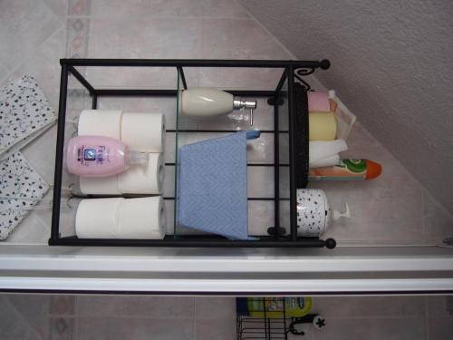 a shelf with rolls of toilet paper in a bathroom at Chalúpka pod Lipkami in Kremnica