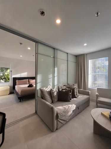 a bedroom with a couch and a bed in a room at Shaomi South Beach in Miami Beach