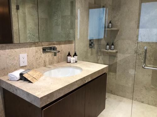 a bathroom with a sink and a shower at Hotel Casa Ensenada Luxury Boutique Hotel in Mexico City