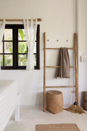 a room with a shelf and a basket at Coconut Beach Bungalows in Chaloklum