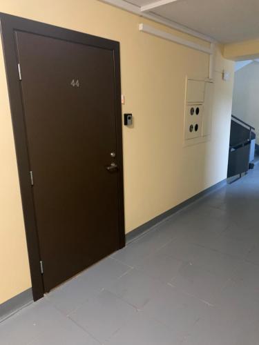 a black door in a room with a tile floor at Brieza Apartment Sigulda in Sigulda