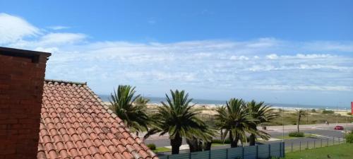 a view of the beach from a house at Hotel Jardim do Mar in Torres