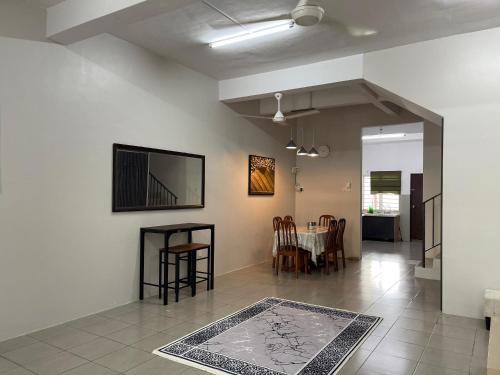 a living room with a table and a dining room at LestariHome1, KLIA Sepang in Sepang
