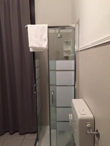 a bathroom with a glass shower and a toilet at Low Cost Ferrara in Ferrara