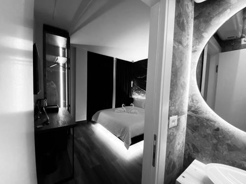 a bedroom with a bed and a mirror at Tirana Central Rooms Blloku in Tirana