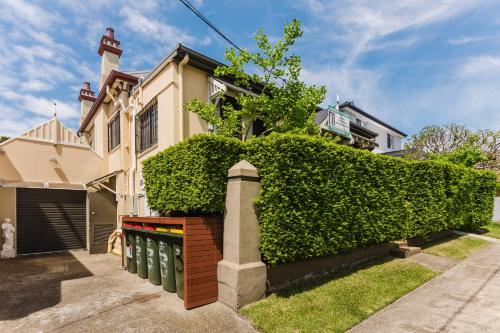 a house with a hedge in front of it at Randwick City Lodge 2 in Sydney
