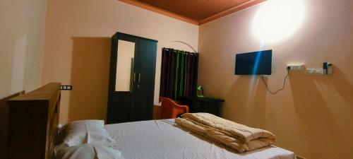 Katil atau katil-katil dalam bilik di Nirmalyam Homestay