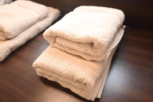 a stack of towels sitting on top of a table at Къща за Гости БАРБЕЛ in Golyam Izvor