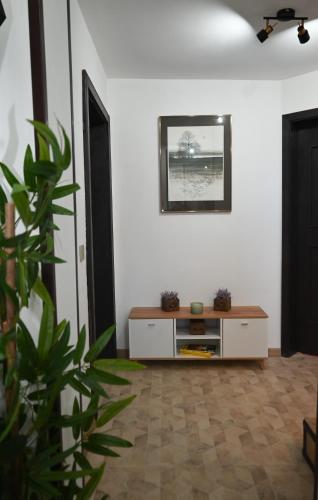 a living room with a table and a plant at Къща за Гости БАРБЕЛ in Golyam Izvor