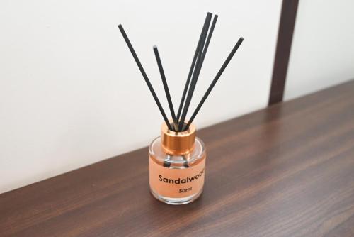 a jar with sticks in it sitting on a table at Къща за Гости БАРБЕЛ in Golyam Izvor