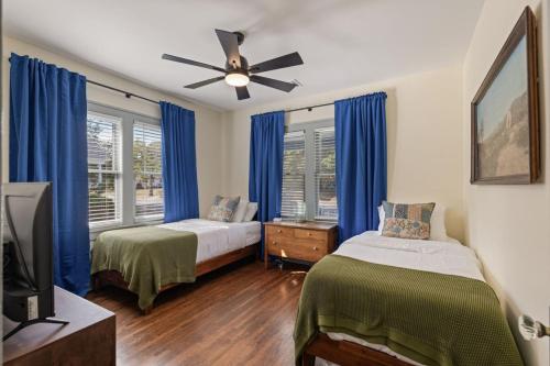 a bedroom with two beds and a ceiling fan at Travelin On Tulsa Time-Near Expo, TU, Downtown in Tulsa