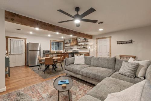 a living room with a couch and a kitchen at Rustic Charm Owasso Retreat in Owasso