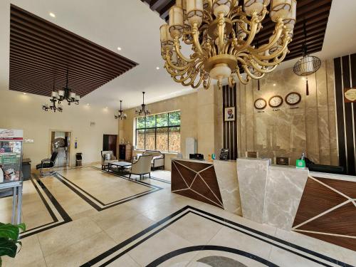a large room with a chandelier and a living room at Dmall Hotel in Kigali