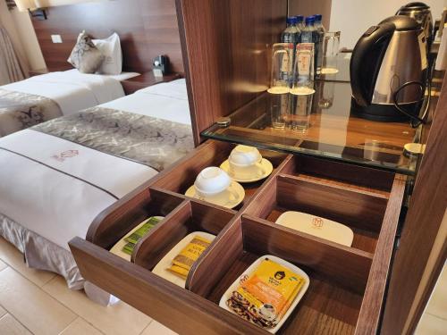 a drawer in a hotel room with food in it at Dmall Hotel in Kigali