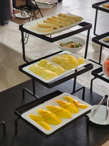 a buffet with several trays of food on a table at Dmall Hotel in Kigali