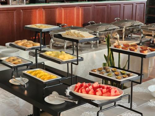 a buffet with many trays of different types of food at Dmall Hotel in Kigali