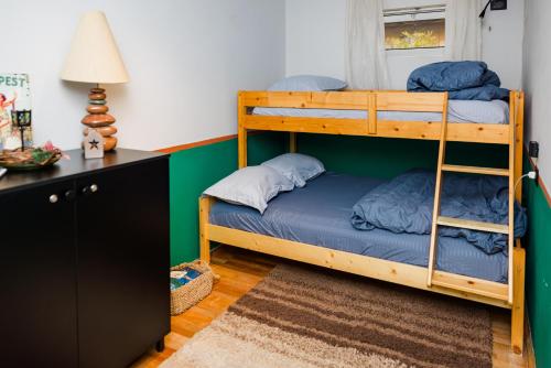 a bedroom with two bunk beds and a desk at The Bearded Dad Hostel in Tirana