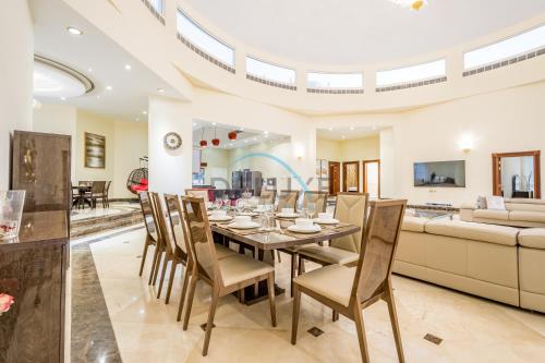 a dining room with a table and chairs and a couch at Country-side Farm Villa Best for Group Gatherings by Deluxe Holiday Homes in Fujairah