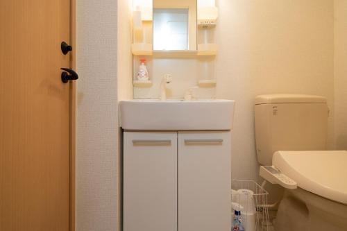 a small bathroom with a sink and a toilet at Belle Lead 105 in Tokyo