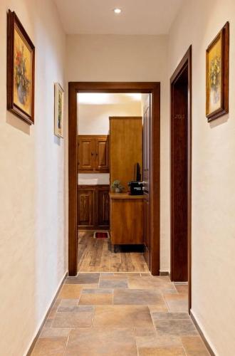 a hallway with a door leading to a kitchen at Bujtina Jaki in Gjakove