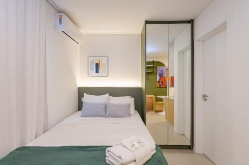 una camera da letto con un letto e uno specchio di Log! Curitiba a Curitiba