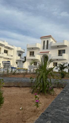 a row of white apartment buildings on the beach at Desert Hotel Dahab in Dahab