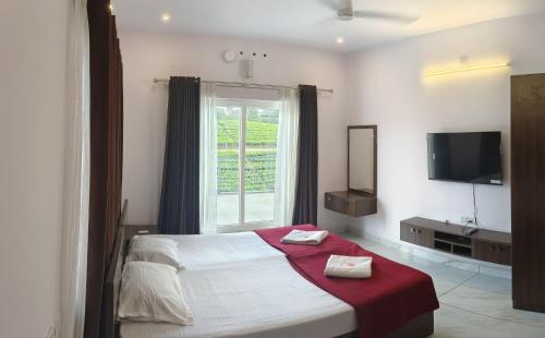 a bedroom with a large bed and a window at Laas Villa Vagamon in Vagamon