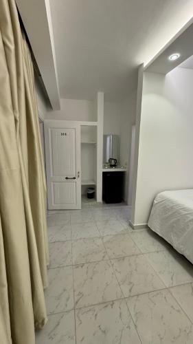 a bedroom with a bed and a tiled floor at Desert Hotel Dahab in Dahab