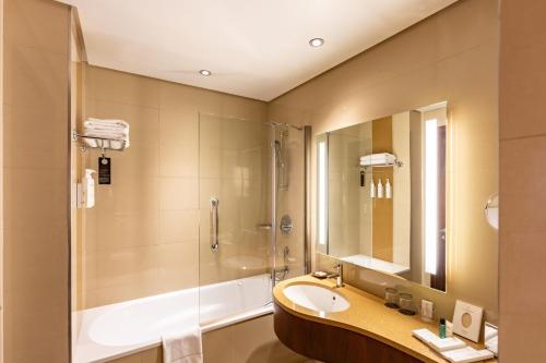 a bathroom with a sink and a shower at Courtyard by Marriott Riyadh Olaya in Riyadh