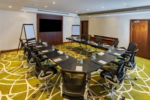 a conference room with a long table and chairs at Courtyard by Marriott Riyadh Olaya in Riyadh