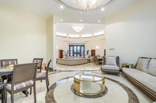 a living room with a couch and a table at Country-side Farm Villa Best for Group Gatherings by Deluxe Holiday Homes in Fujairah