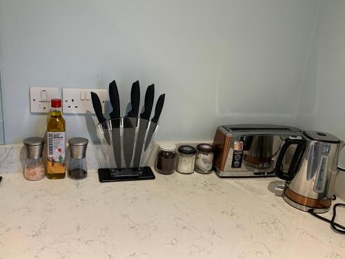 a kitchen counter with a bunch of kitchen utensils at 3 Beechwood at Thoulstone Park in Westbury