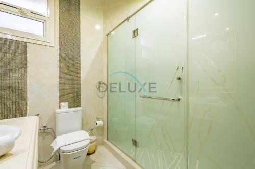 a bathroom with a shower and a toilet at Country-side Farm Villa Best for Group Gatherings by Deluxe Holiday Homes in Fujairah