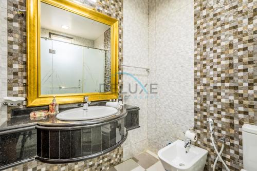 a bathroom with a sink and a mirror and a toilet at Country-side Farm Villa Best for Group Gatherings by Deluxe Holiday Homes in Fujairah