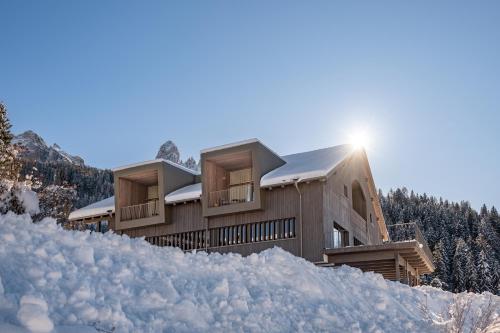 a house on a hill covered in snow at Hotel Bewaller in Obereggen