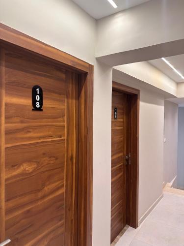 a hallway with wooden doors in a house at Giza Palace Pyramids View in Cairo