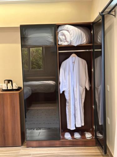a room with a closet with a bed at Giza Palace Pyramids View in Cairo